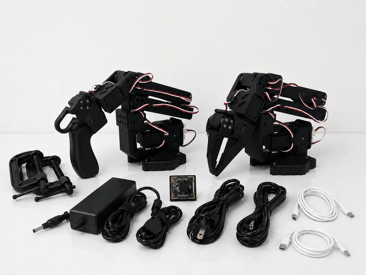 A complete SO-ARM101 kit — leader arm, follower arm, camera, cables and clamps