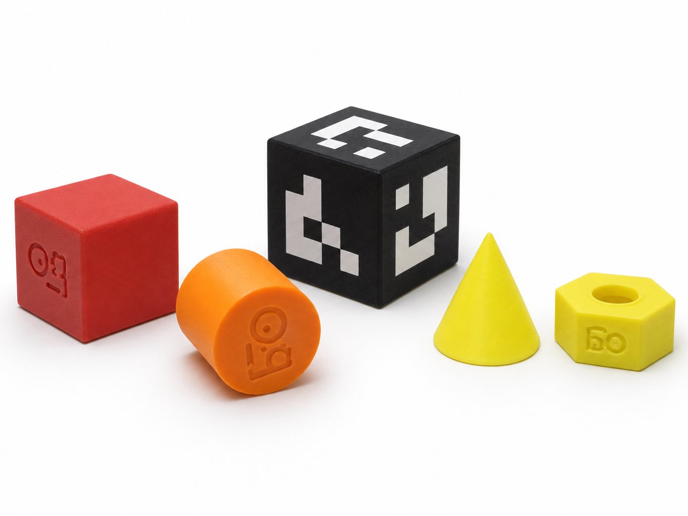 The training objects and the ArUco cube — what the pick-and-place and vision modules are written around.