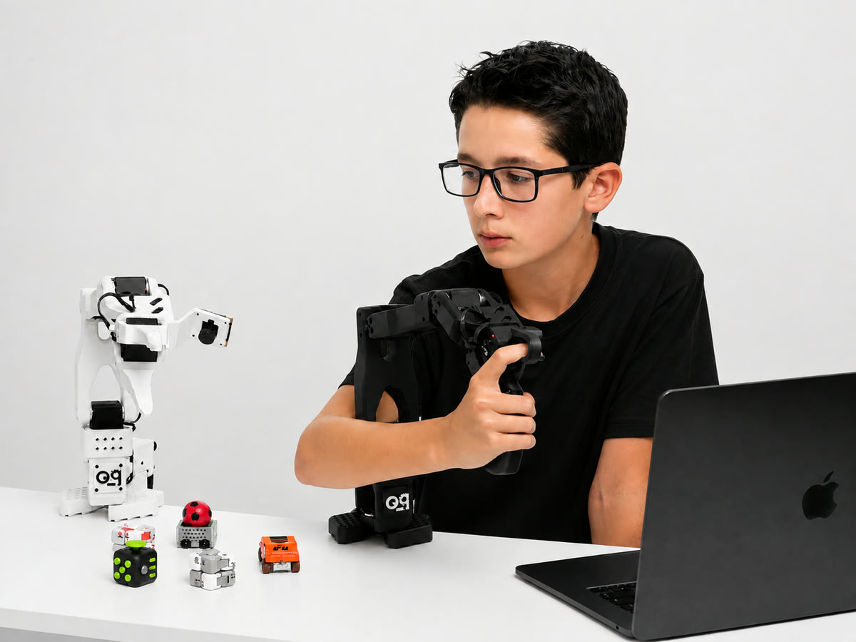A teenager at a desk operating the SO-ARM101 robotic arm